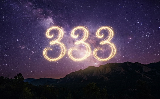 Ethereal golden sparkler light painting of the 333 angel number floating in a deep purple and violet starry night sky above a dark mountain silhouette, symbolizing spiritual growth, manifestation, and divine guidance